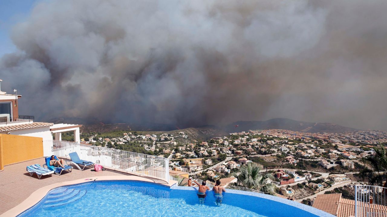Two men watch a wildfire from afar as it burns in Benitachell, Spain, on Monday, September 5. <a href="https://www.theguardian.com/world/2016/sep/05/wildfire-near-spanish-resort-javea-evacuations" target="_blank" target="_blank">According to the Guardian</a>, authorities said more than 200 firefighters were working to combat the forest blaze near Valencia, and more than 1,000 residents and tourists were forced to flee. 