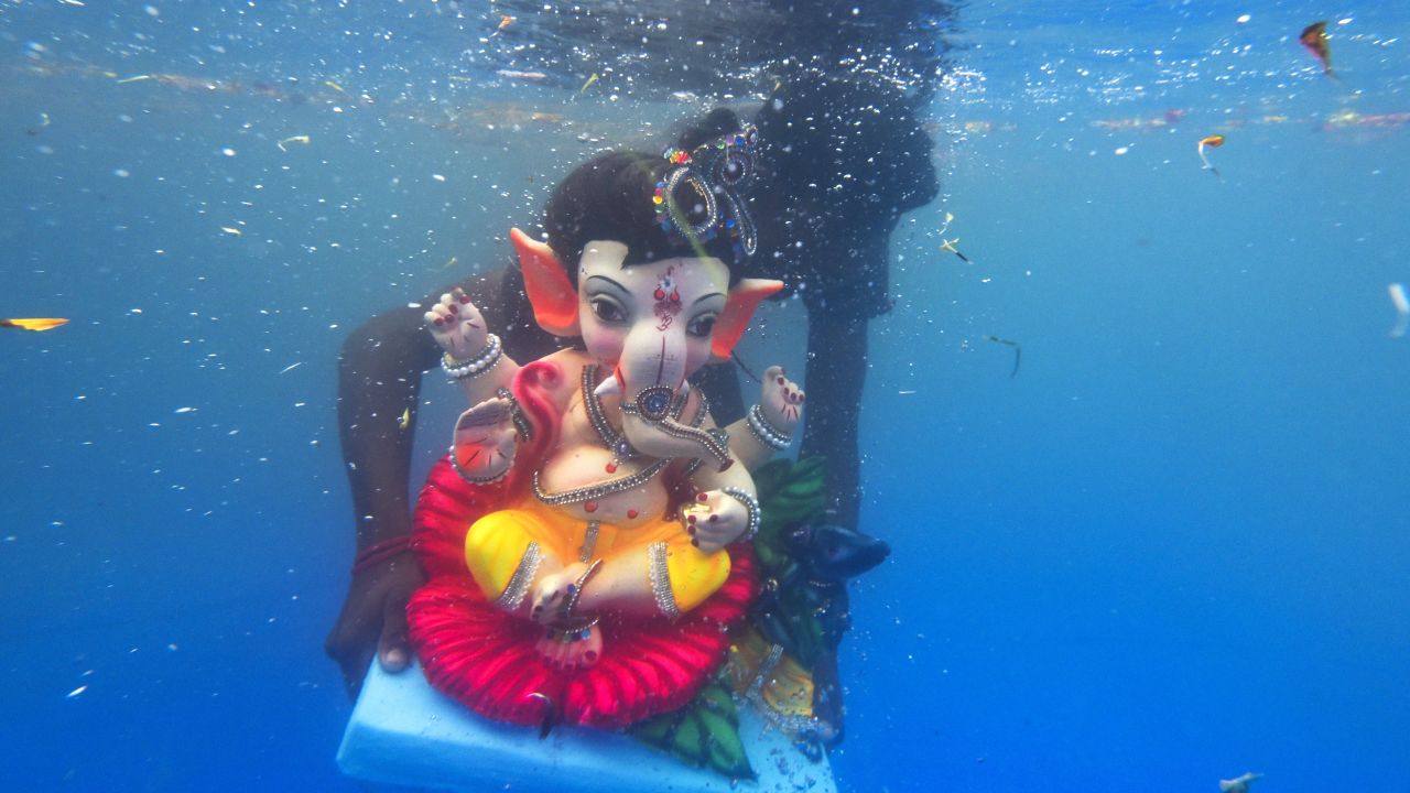 A model of the Hindu god Ganesha is submerged in a pond during a festival in Mumbai, India, on Tuesday, September 6. The elephant-headed Ganesha is revered as a remover of obstacles.