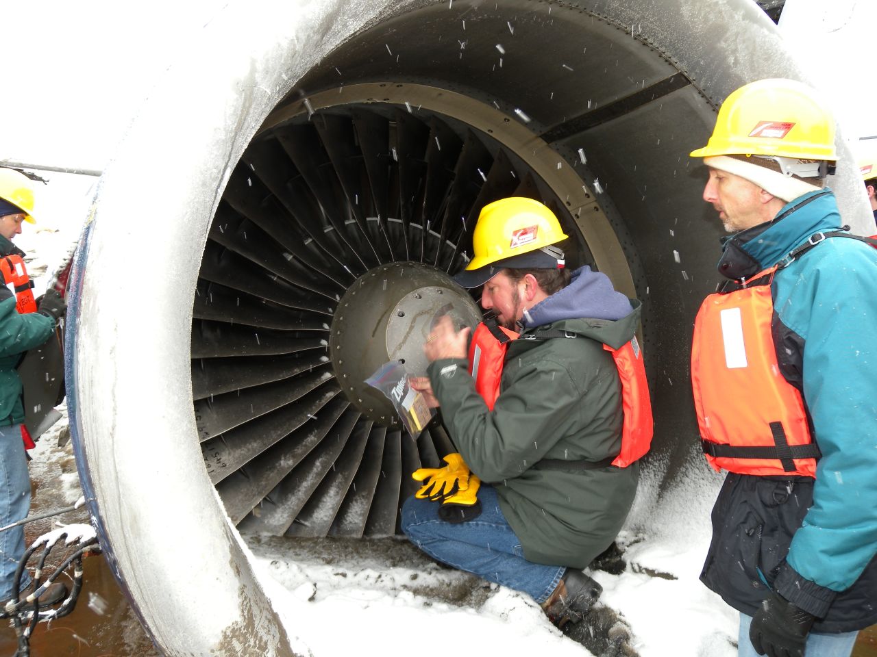 Mike Begier, national coordinator of the USDA Airport Wildlife Hazards Program investigates bird strike remains inside a damaged engine of US Airways Flight 1549 in 2009.