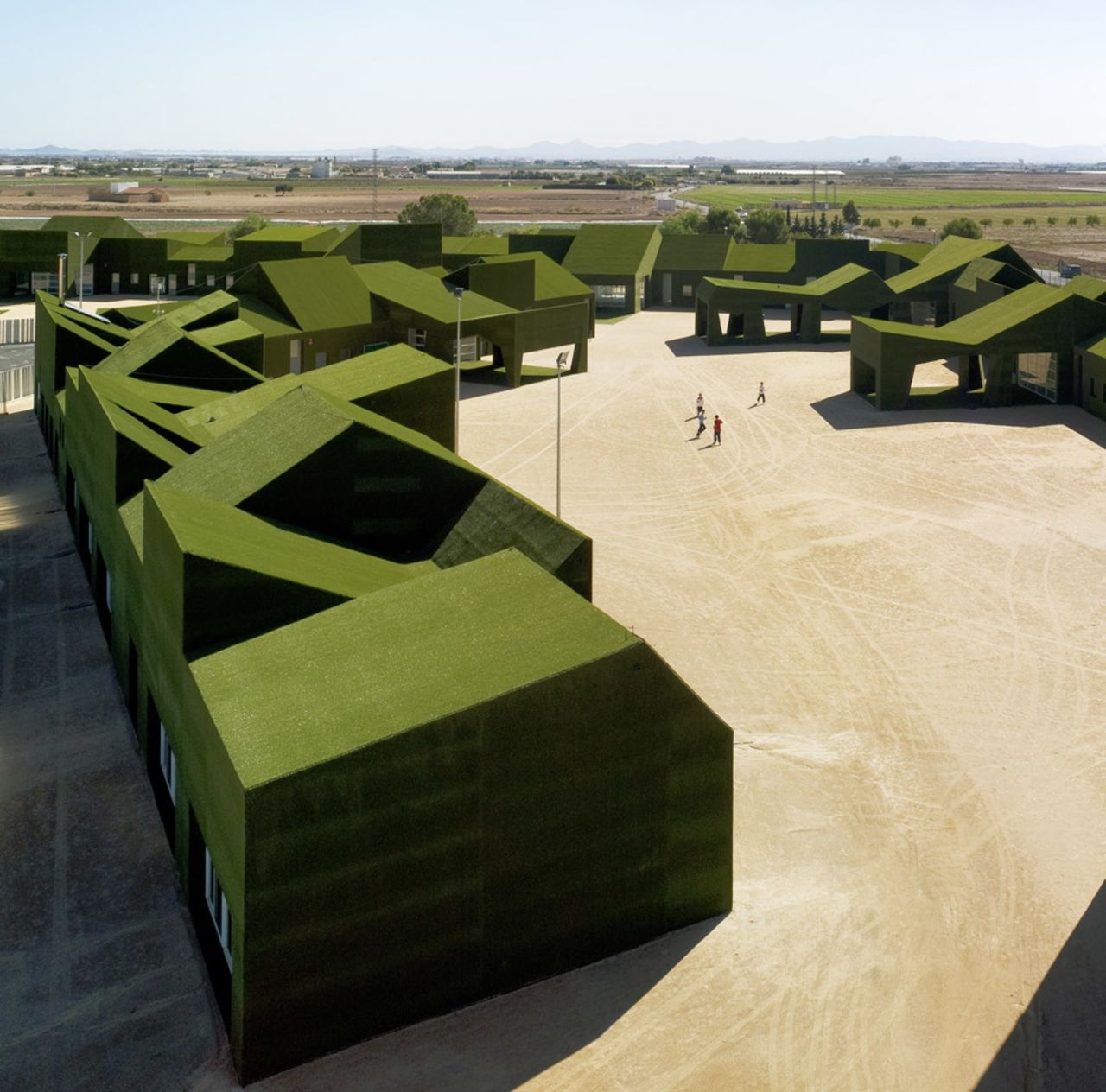 Located on the outskirts of this small town in Murcia, Spain, this school is fully wrapped in a green carpet of artificial turf, and is built on top of a two-meter high perimeter wall to protect it from the region's heavy rains. (Photo credit: David Frutos)