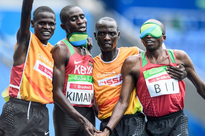 Kenya's Samwel Kimani (2L) and guide James Boit (L) got the medal procession under way in Rio, winning the first gold of the Paralympic Games in the men's T11 5,000m.