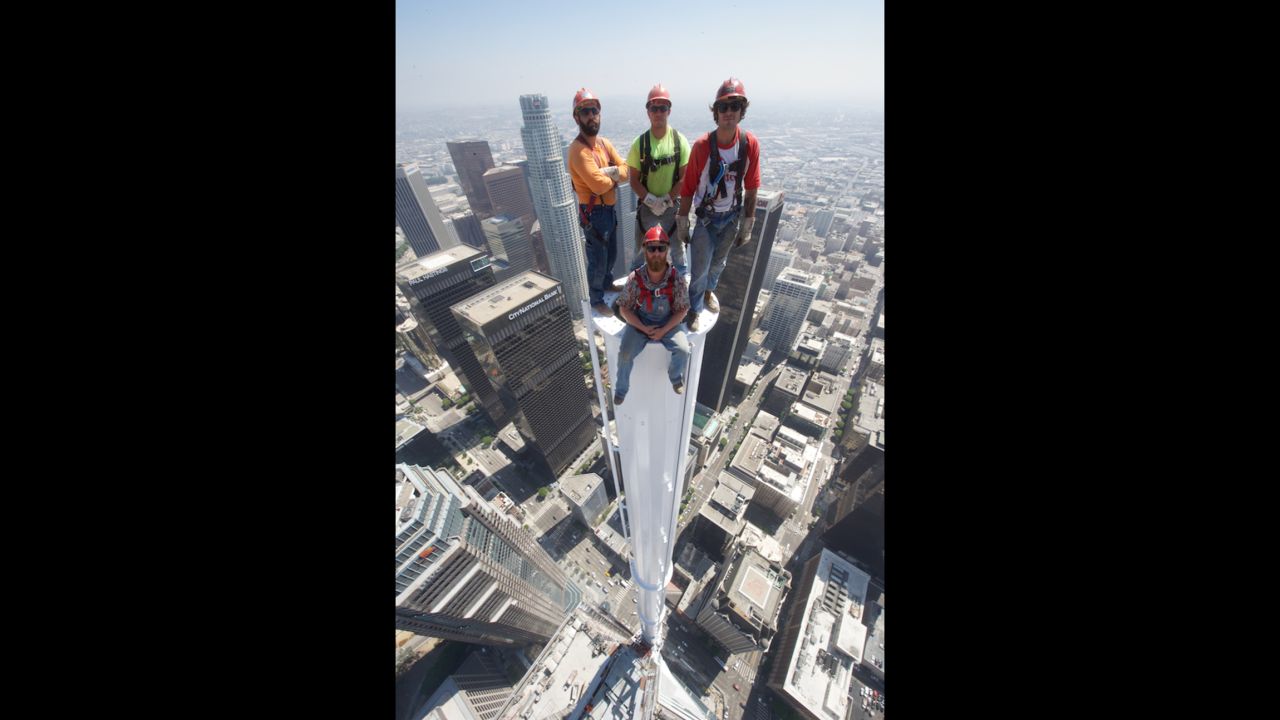 The iron workers responsible for building this spire on the Wilshire Grand Center in Los Angeles posed atop it in a jaw-dropping photo on Saturday.<br />