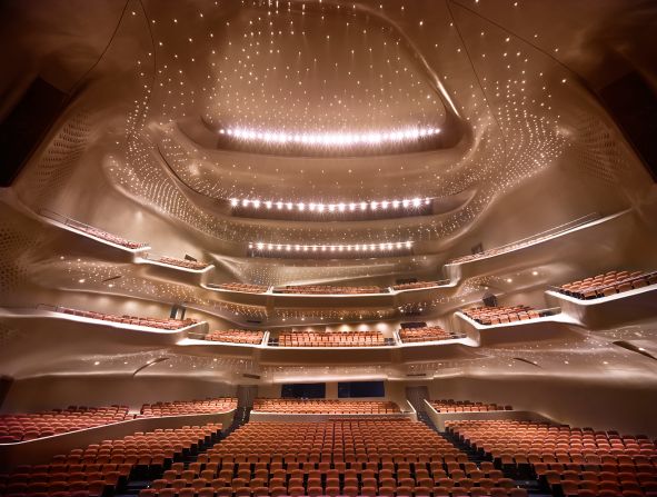 Built in 2010, China's riverside Guangzhou Opera House has the signature touch of the late Zaha Hadid. Its contoured profile was inspired by river valleys and the way they constantly change shape through the process of erosion. Constructed from 12,000 tons of steel, the Opera House includes an 1,800-seat and a 400-seat theater.