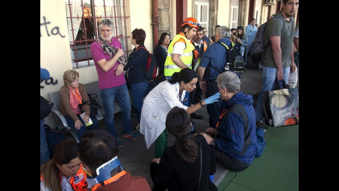 Spanish emergency service workers tend to injured passengers near O Porrino. 