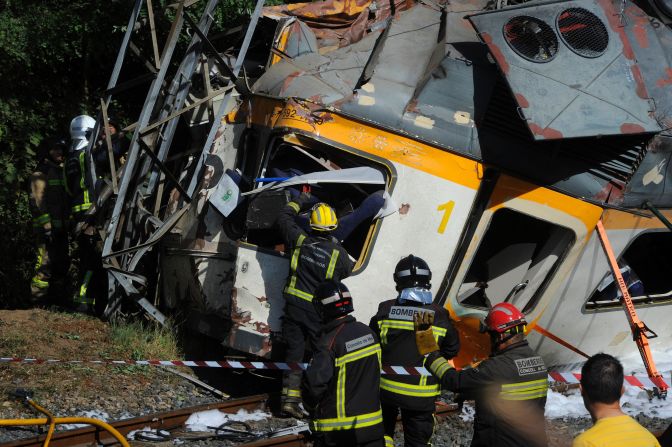 Firefighters and rescuers search for victims of the train derailment. 