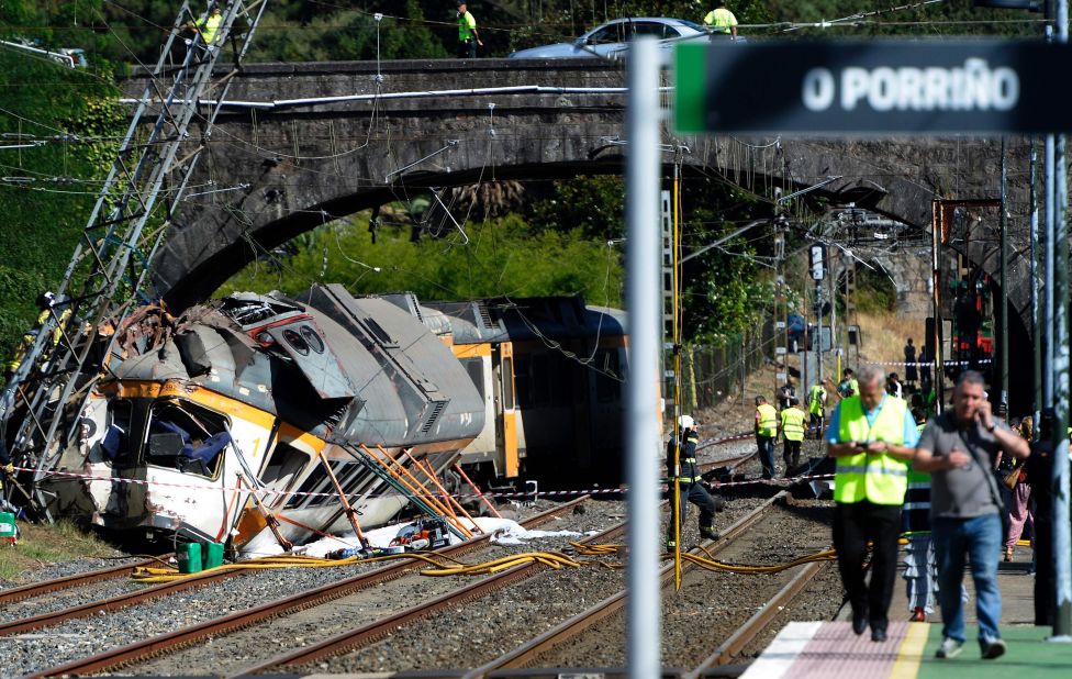 First responders work at the scene of a train derailment near O Porrino station in northwestern Spain's Galicia region on Friday, September 9. At least four people were killed and nearly 50 others injured in the crash, authorities said.