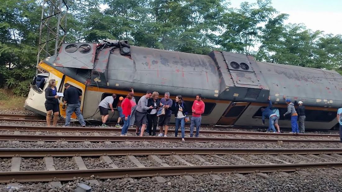 Injured passengers receive help as they move away from the wreckage. The train was en route from Vigo, Spain, to Oporto, Portugal, when the derailment occurred. 