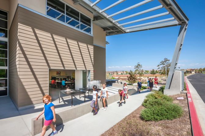 Teaching students from preschool through to grade 6, this school is designed to be grid neutral and currently offsets all of its energy needs with integrated solar cells, according to one of the lead architects, John Dale. The classrooms are clustered into three small learning communities around shared resource areas, with the ground floor spaces providing indoor and outdoor learning opportunities. 