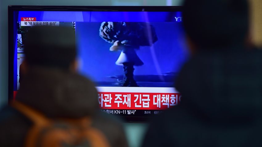 TOPSHOT - ADDITION-
People watch a news report on North Korea's first hydrogen bomb test at a railroad station in Seoul on January 6, 2016. South Korea "strongly" condemned North Korea's shock hydrogen bomb test and vowed to take "all necessary measures" to penalise its nuclear-armed neighbour.  The image shown on TV shows files images from other nuclear tests from other countries and the caption in red at the bottom of the screen reads "the Blue House will convene an emergency meeting of the NSC, the National Security Council."   AFP PHOTO / JUNG YEON-JE / AFP / JUNG YEON-JE        (Photo credit should read JUNG YEON-JE/AFP/Getty Images)