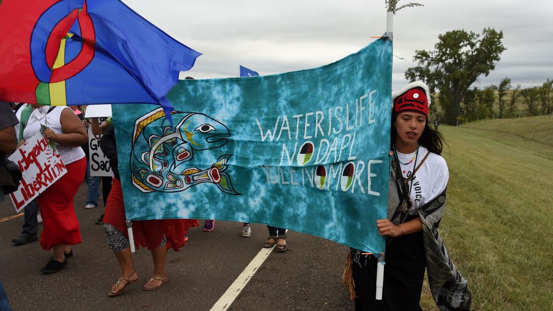 Native Americans march to the site of a sacred burial ground on September 4.