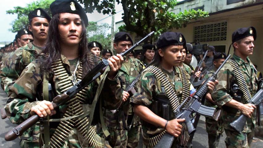 SAN VICENTE, COLOMBIA:  Guerrillas of the Marxist Revolutionary Armed Forces of Colombia (FARC) march in a military parade 07 February 2001 in San Vicente. Amid rising tension and international pressure for dialogue, Colombian President Andres Pastrana is set to meet Marxist rebel leader Manuel Marulanda 08 February 2001 in a bid to end a civil war that has turned Colombia into one of the world's most violent nations. AFP PHOTO/LUIS ACOSTA (Photo credit should read LUIS ACOSTA/AFP/Getty Images)