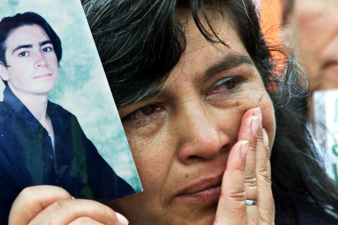 A mother holds a photo of her kidnapped son at a demonstration in Bogota in 2001. 