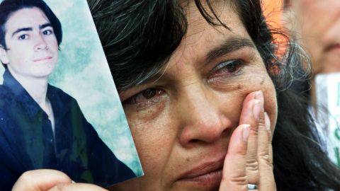 A mother holds a photo of her kidnapped son at a demonstration in Bogota in 2001.