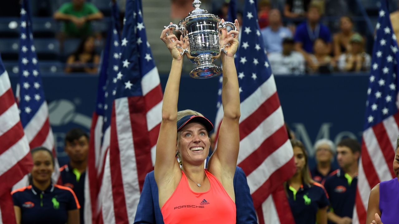 Angelique Kerber of Germany holds up her winning trophy after defeating Karolina Pliskova of Czech Republic in their 2016 US Open Womens Singles final match at the USTA Billie Jean King National Tennis Center in New York on September 10, 2016.
New world number one Angelique Kerber won the US Open title on Saturday with a battling 6-3, 4-6, 6-4 victory over Karolina Pliskova of the Czech Republic. / AFP / Timothy A. CLARY (Photo credit should read TIMOTHY A. CLARY/AFP/Getty Images)