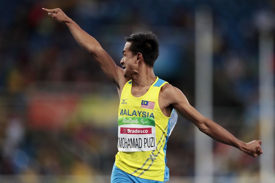 Mohamad Ridzuan Puzi celebrates as he crosses the line in the T36 100m final, winning Malaysia's first ever Paralympic gold medal.
