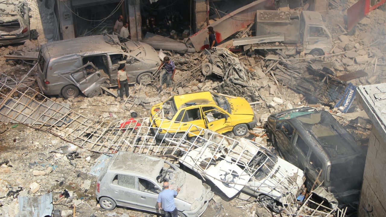 Syrians search for victims at the scene of a reported airstrike in Idlib on September 10.