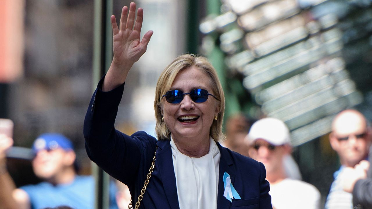 US Democratic presidential nominee Hillary Clinton waves to the press as she leaves her daughter's apartment building on September 11, 2016.