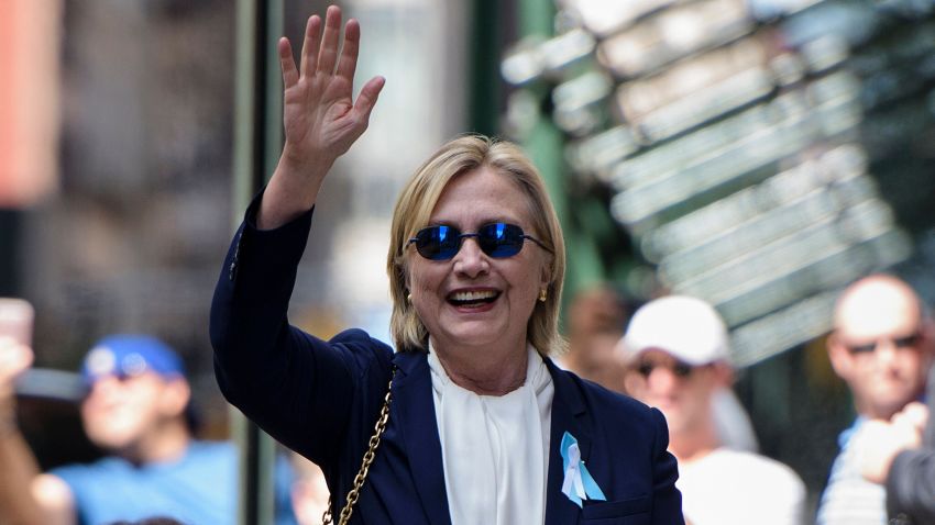 US Democratic presidential nominee Hillary Clinton waves to the press as she leaves her daughter's apartment building after resting on September 11, in New York.
