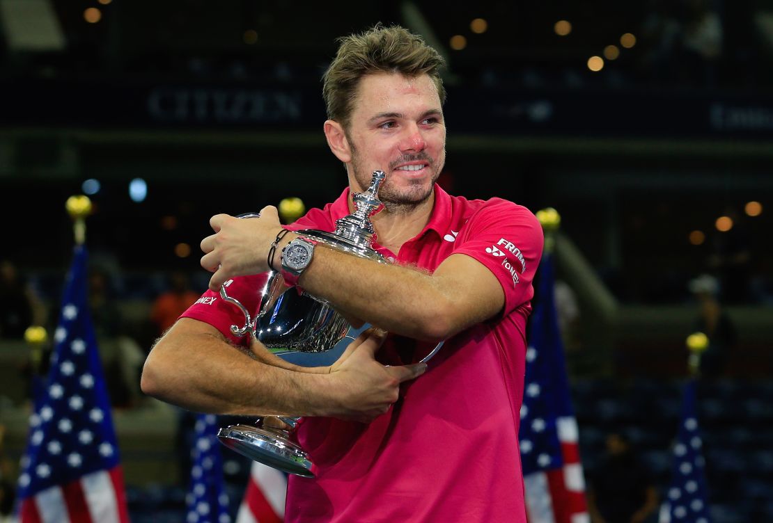 Wawrinka celebrates with the US Open trophy after beating Novak Djokovic.