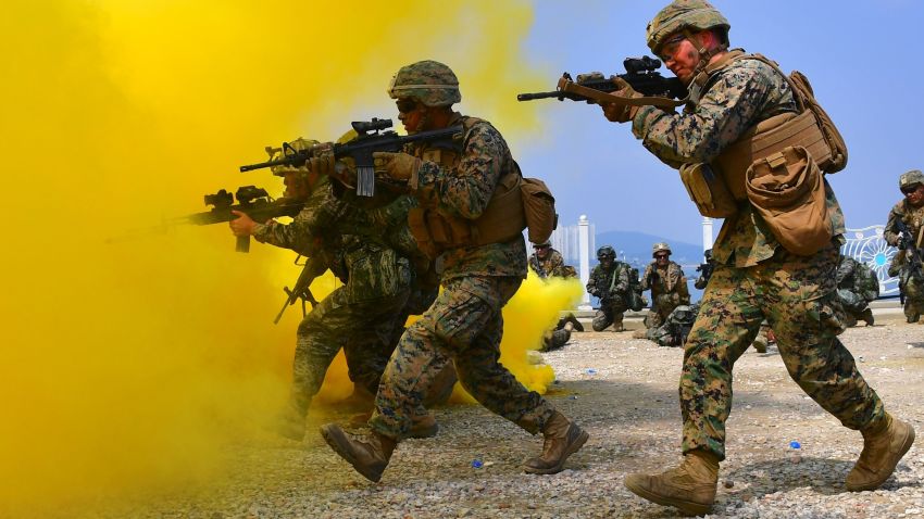 South Korean and US marines move to a position during a re-enactment of the Incheon landing to mark the 66th anniversary of the start of Operation Chromite, the battle that turned the tide in the Korean War, in the western port city of Incheon on September 9, 2016.