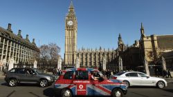 LONDON, ENGLAND - MARCH 26:  A taxi with a Union Flag livery drives through Parliament Square on March 26, 2012 in London, England.  (Photo by Oli Scarff/Getty Images)
