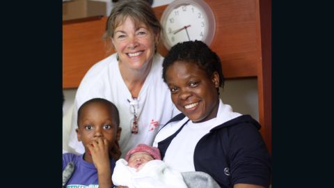 The newborn with mother Faith, big brother Rollres and MSF midwife Jonquil Nicholl.
