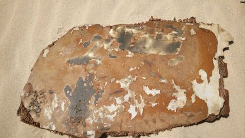 Debris piece with burn/scorch marks to both sides.