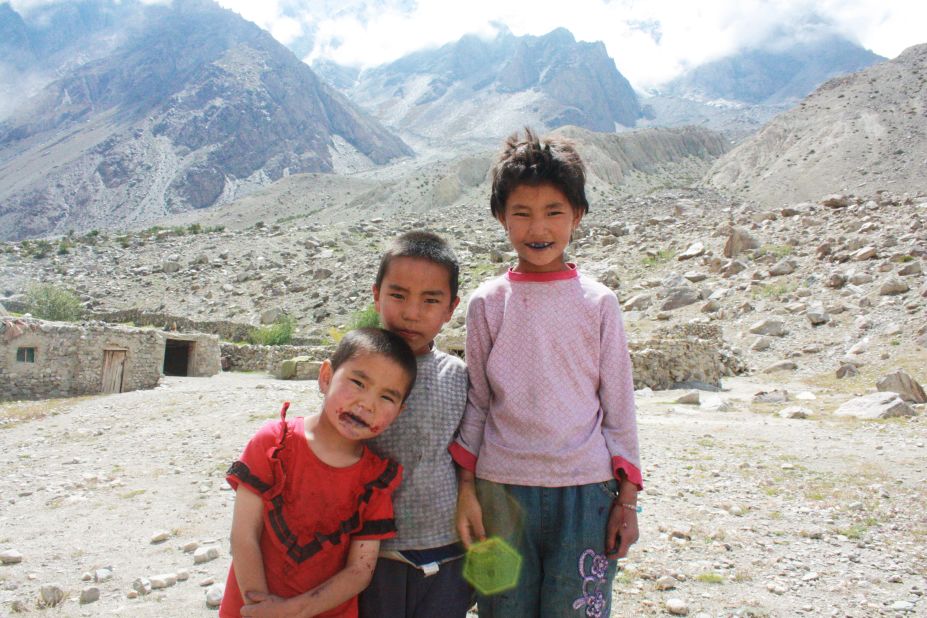 Children beside a stone Kyrgyz house along the Karakoram Highway.