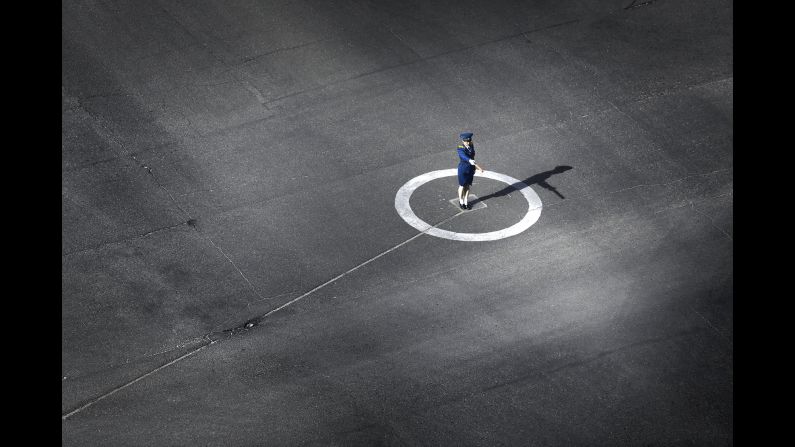 A police officer directs traffic. "The biggest challenge which I've had to accept is not being able to go where I want to go when I want to go there, because we must travel with a government guide," Wong said. "I can't just walk on the street by myself with my camera and make photos."