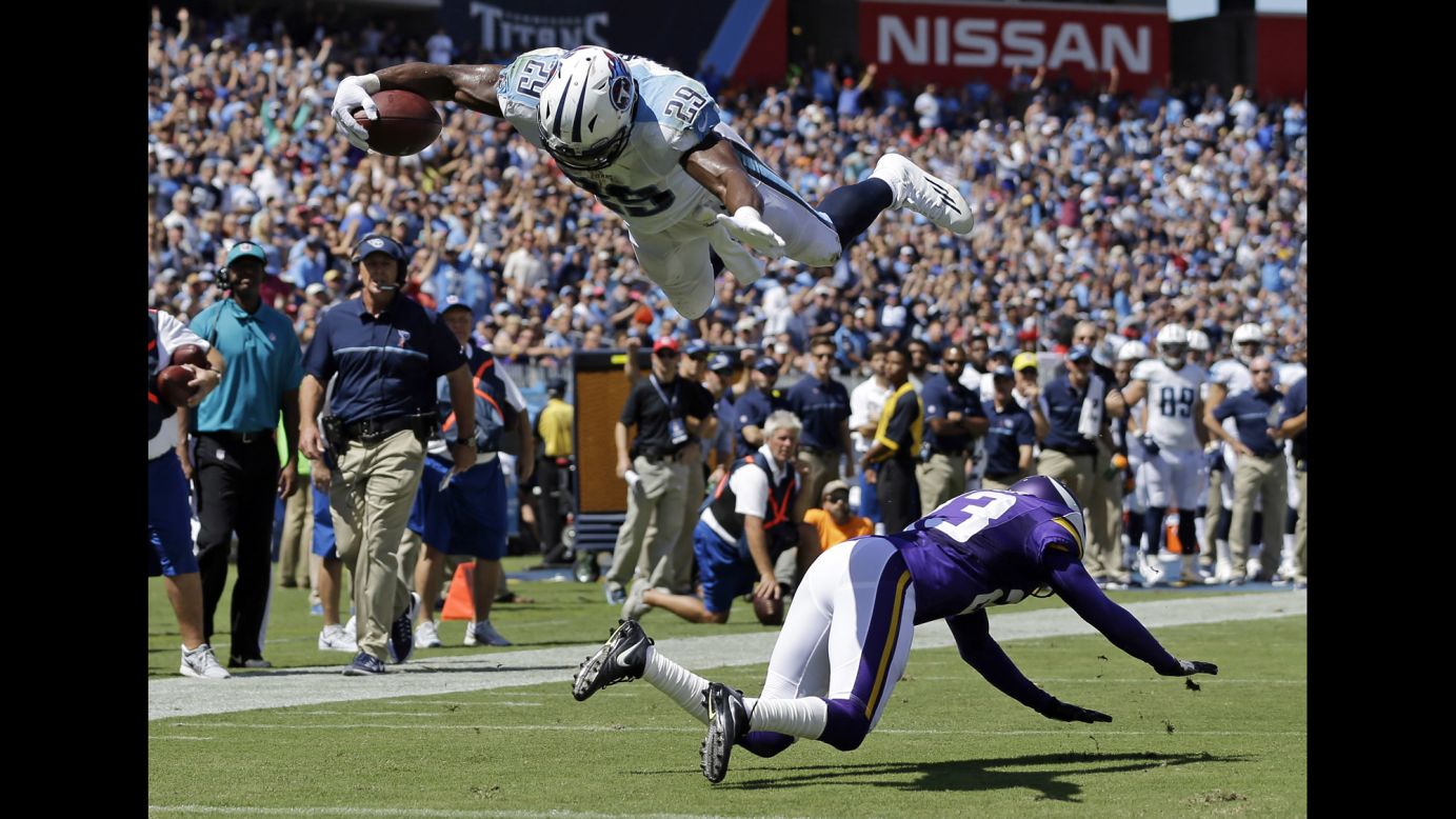 Tennessee's DeMarco Murray dives for a touchdown over Minnesota's Terence Newman during an NFL game in Nashville on Sunday, September 11. Minnesota won 25-16.