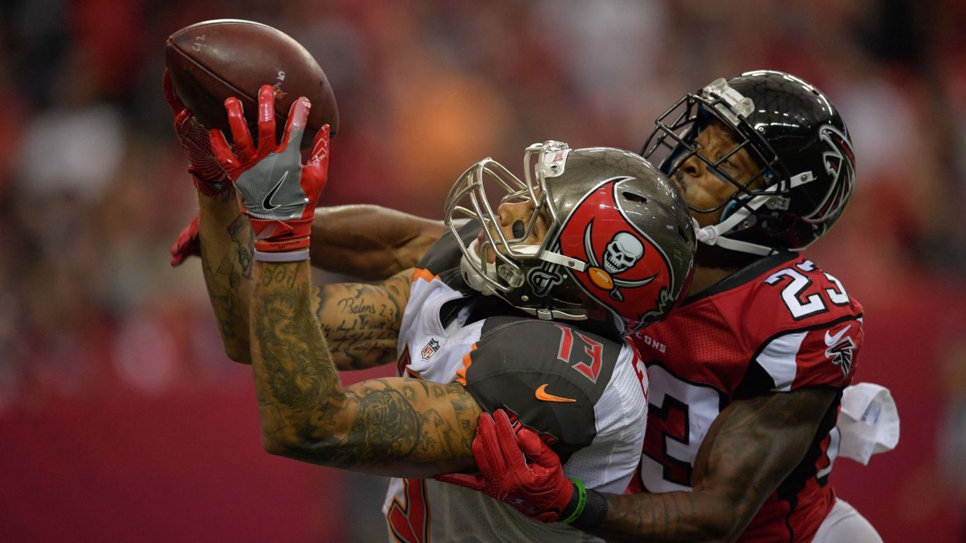 Mike Evans of Tampa Bay catches a touchdown pass in front of Atlanta's Robert Alford during the second half in Atlanta on Sunday, September 11. Tampa Bay won 31-24.