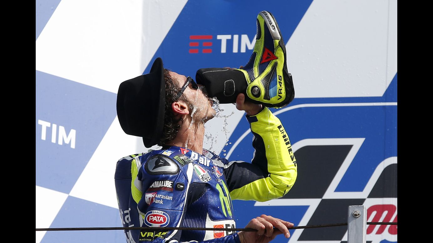Motorcycle racer Valentino Rossi drinks from his boot after finishing second in the San Marino Grand Prix in Misano Adriatico, Italy, on Sunday, September 11. 