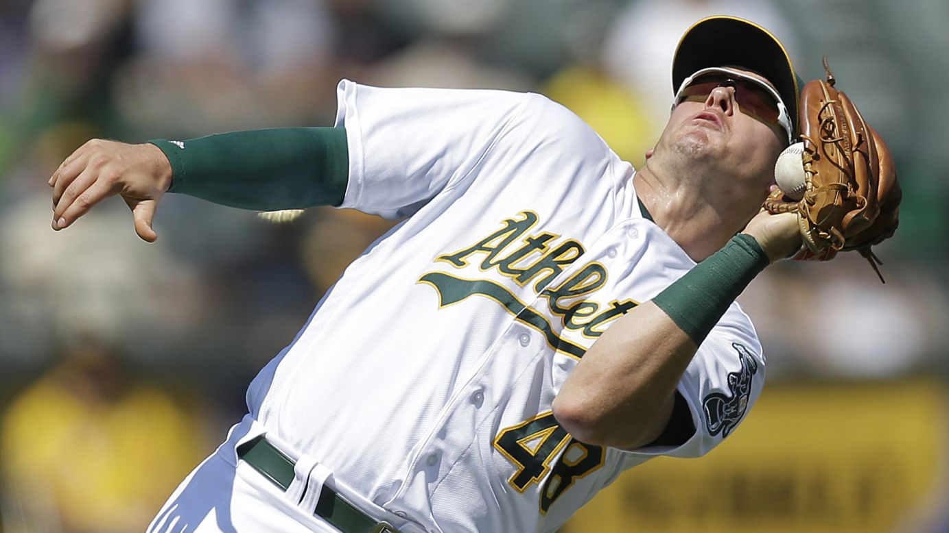Oakland's Ryon Healy catches the ball in the third inning of a game against Los Angeles in Oakland, California, on Wednesday, September 7. Oakland won 4-1.