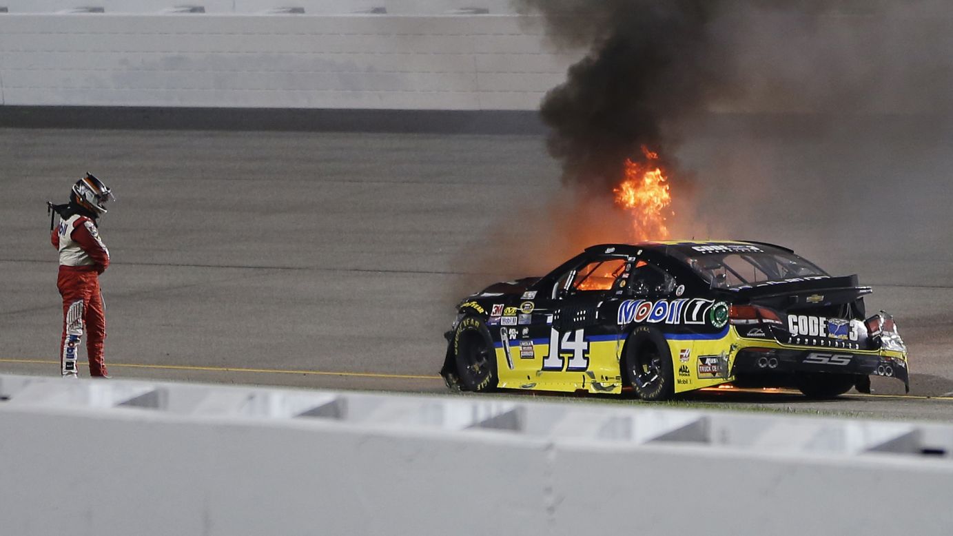 Tony Stewart watches as his car catches fire after crashing in the NASCAR Federated Auto Parts 400 in Richmond, Virginia, on Saturday, September 10. 