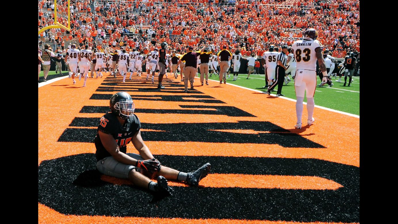 Oklahoma State's Chad Whitener sits in the Central Michigan end zone after a touchdown by Central Michigan's Corey Willis during a game in Stillwater, Oklahoma, on Saturday, September 10. Central Michigan stunned Oklahoma State with a last-play touchdown winning the game 30-27.