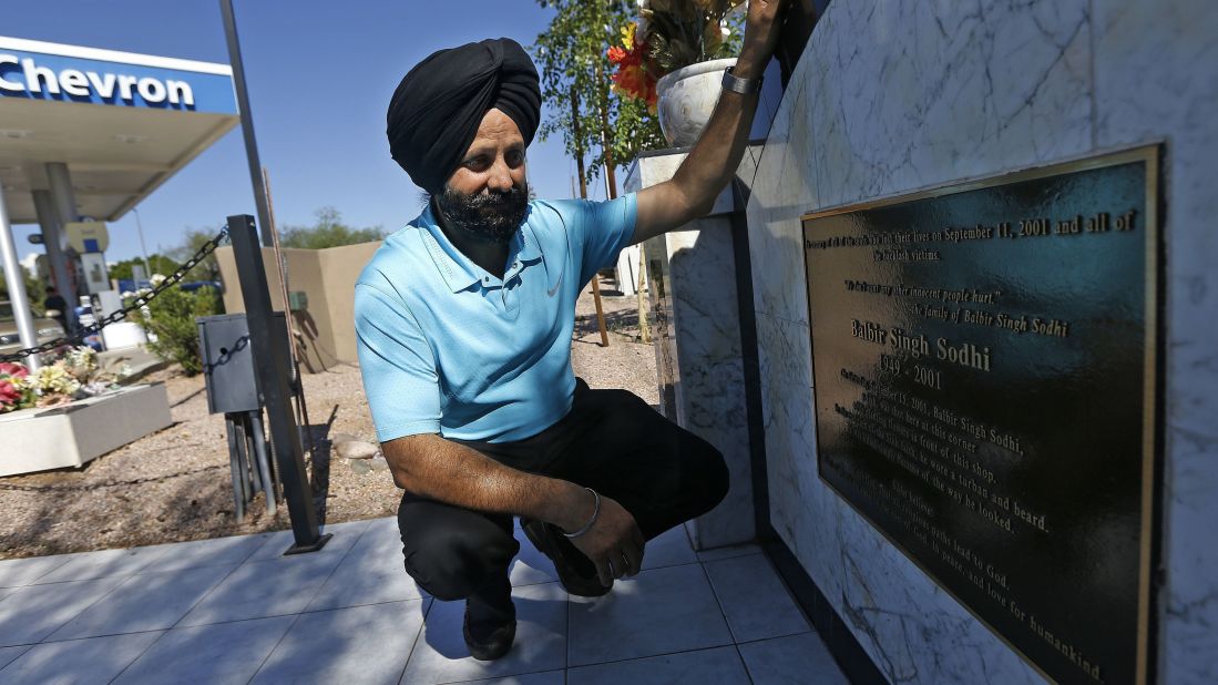 The first victim of a revenge killing after the September 11, 2001, attacks was not a Muslim but a Sikh. Balbir Singh Sodhi was gunned down at the gas station he managed in Mesa, Arizona, by a man who wanted to kill "towel heads." Balbir's younger brother, Rana Singh Sodhi, kneels next to a memorial the family erected at the gas station. He became a voice for the Sikh community after his brother's murder.