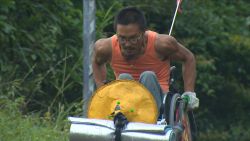 Quan Peng has pushed his wheelchair 3,000 miles across China -- as his bulging biceps prove.