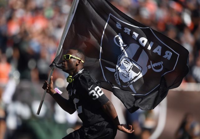 Leeper carries the Oakland Raiders flag in a break in play against the Denver Broncos in November 2014.