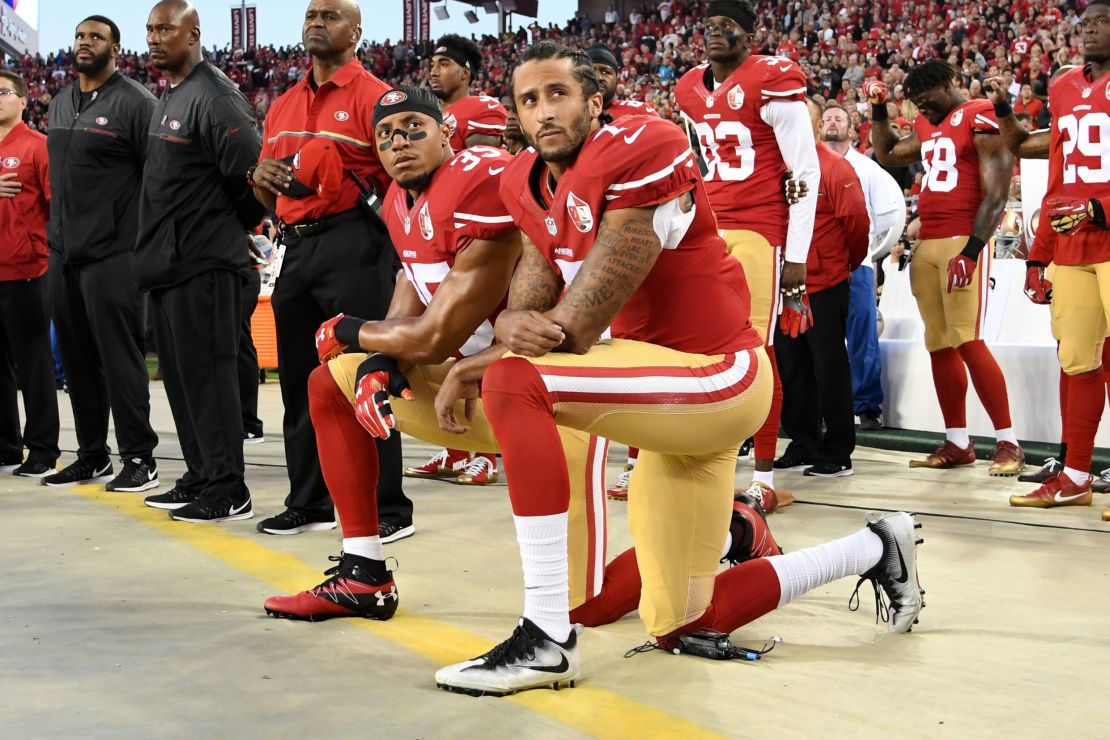 Colin Kaepernick #7 and Eric Reid #35 of the San Francisco 49ers kneel in protest during the national anthem prior to playing the Los Angeles Rams in their NFL game at Levi's Stadium on September 12, 2016. 
