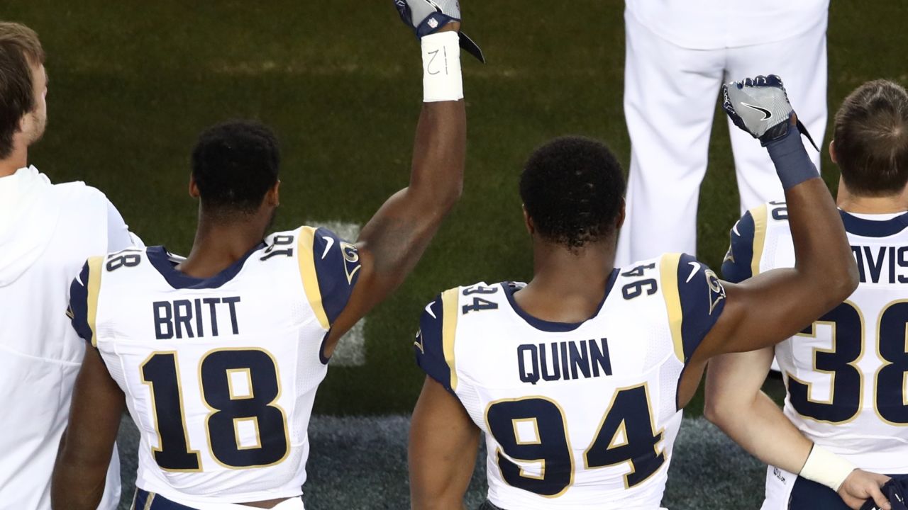 LA Rams' Kenny Britt and Robert Quinn raise their fists in protest prior to their game against the San Francisco 49ers.