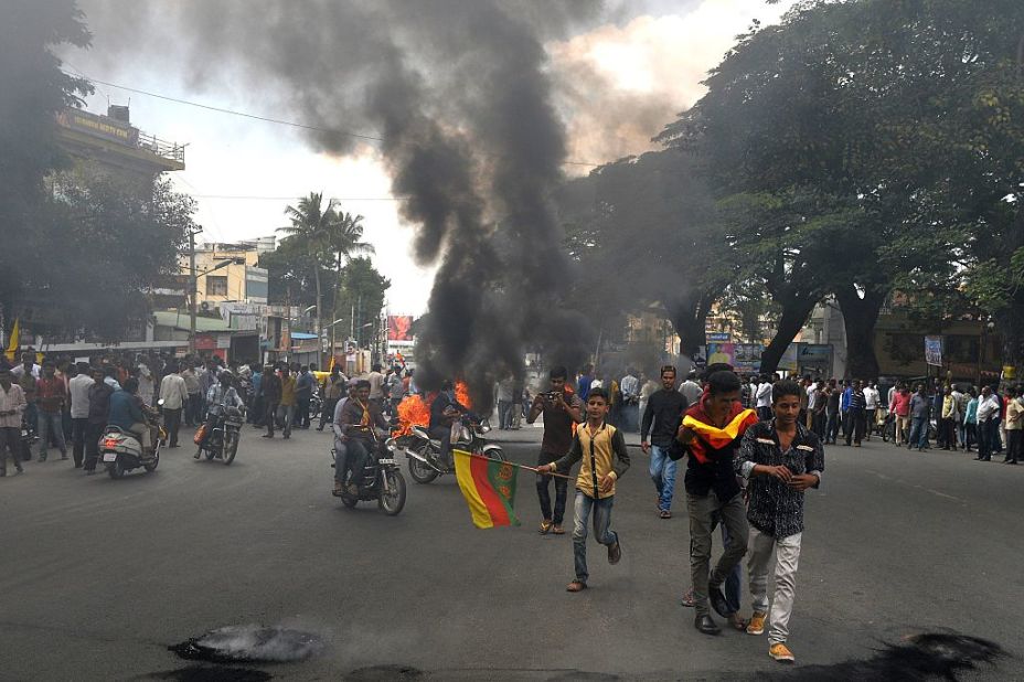 Indian activists burn tires as they blockade traffic on a major connecting road during a statewide strike in Bangalore.