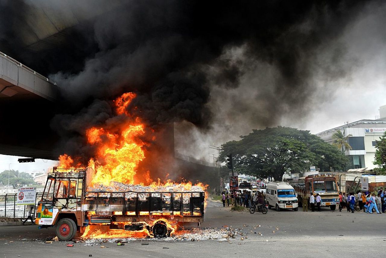 A truck from the state of Tamil Nadu burns Monday, September 12, after pro-Karnataka activists set it afire in Bangalore. 