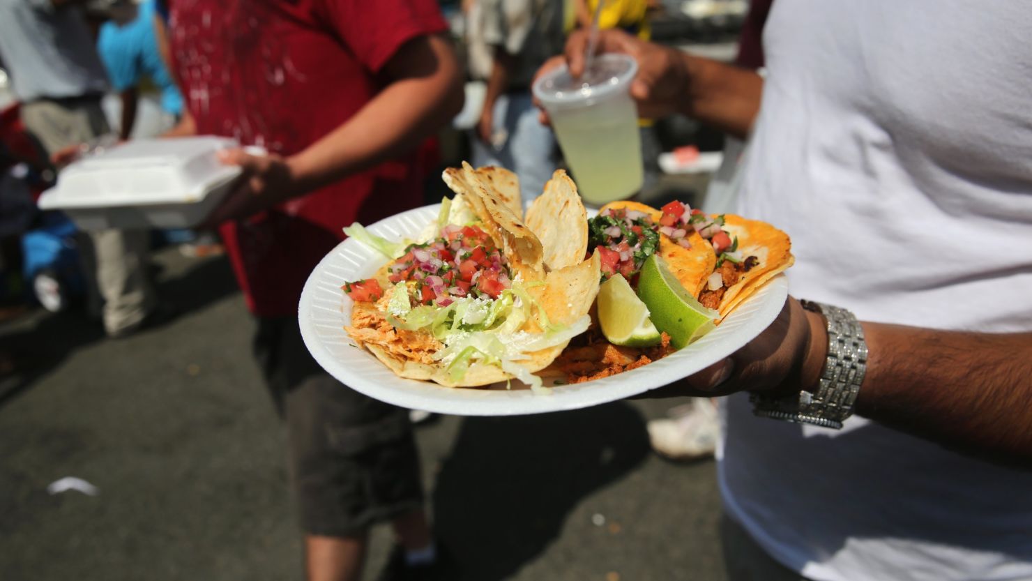 A man carries a plate of tacos on July 20, 2014 in Valhalla, New York.