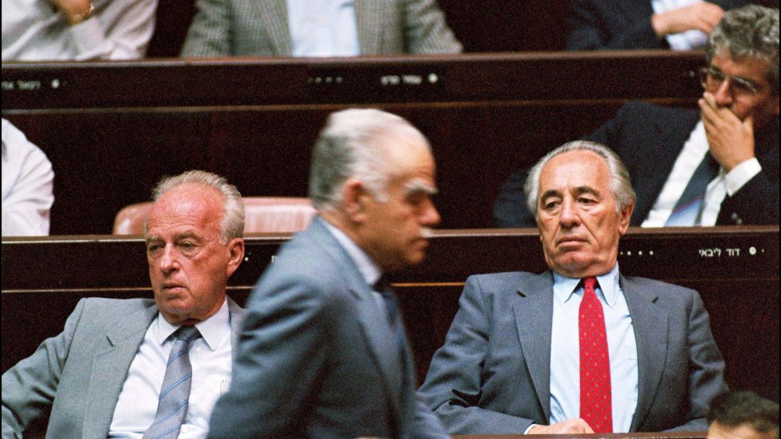 Right-wing Israeli Premier Yitzhak Shamir, center, walks past Labor party leaders Yitzhak Rabin, left, and Shimon Peres during a special Knesset summer session meeting on May 7, 1990, in Jerusalem. 