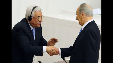 Palestinian Authority President Mahmoud Abbas, left, congratulates President Shimon Peres of Israel after Peres addressed Turkey's Parliament in Ankara on November 13, 2007, becoming the first Israeli President to speak to a Muslim country's legislature. 