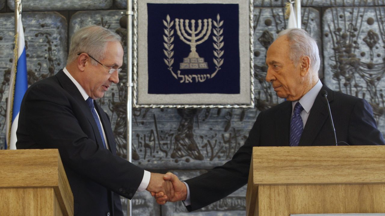 Israeli President Shimon Peres shakes hands with Likud Party leader Benjamin Netanyahu during their press conference in Jerusalem on February 20, 2009.  Peres gave the hawkish Netanyahu, who became Prime Minister the following month, formal permission to put together the country's next government. 