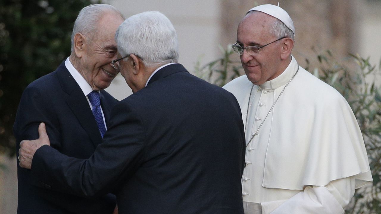 Pope Francis looks on as Israeli President Shimon Peres, left, and Palestinian President Mahmoud Abbas greet each other during an evening of peace prayers at the Vatican on June 8, 2014. 