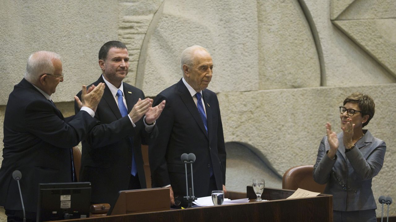 Newly sworn-in Israeli President Reuven Rivlin, left, and Parliament Speaker Yuli Edelstein applaud outgoing President Shimon Peres during a ceremony at the Knesset, Israel's parliament, in Jerusalem on July 24, 2014. Rivlin succeeded Peres, who had promoted peace throughout his long career but whose term ended as Israel was fighting Hamas in Gaza. 