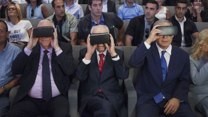 Israeli President Reuven Rivlin, left, former Israeli President Shimon Peres, center, and Israeli Prime Minister Benjamin Netanyahu wear virtual-reality goggles during a presentation at the Peres Center for Peace in Jaffa on July 21, 2016. 