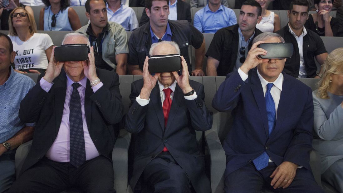 Israeli President Reuven Rivlin, left, former Israeli President Shimon Peres, center, and Israeli Prime Minister Benjamin Netanyahu wear virtual-reality goggles during a presentation at the Peres Center for Peace in Jaffa on July 21, 2016. 